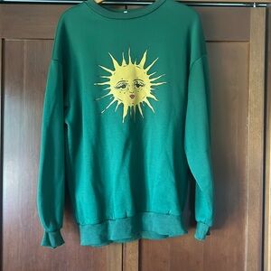 Green crewneck with sun on it
